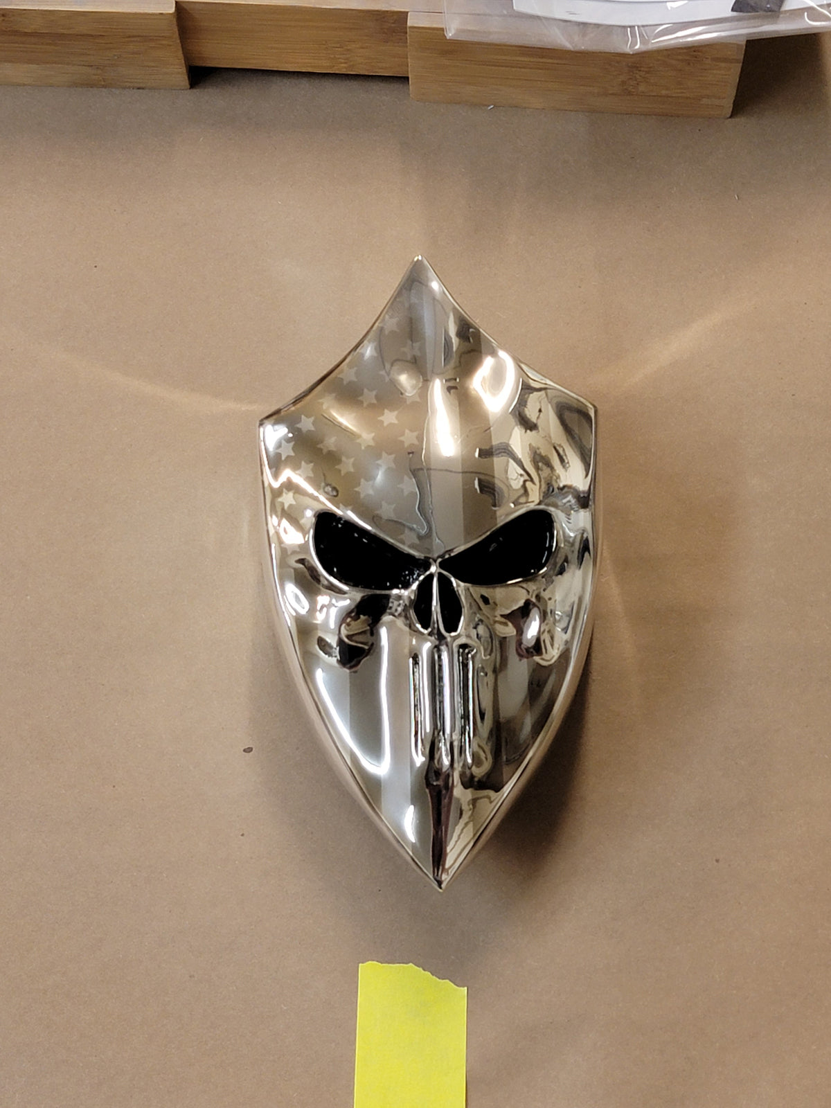Chrome Harley horn cover with punisher stretching through