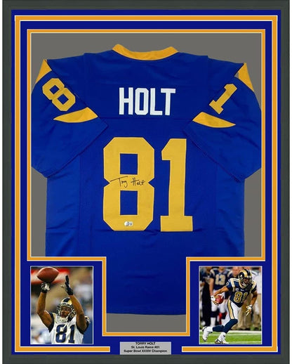 Framed Autographed/Signed Torry Holt 35x39 St. Louis Retro Blue Football Jersey Beckett BAS COA