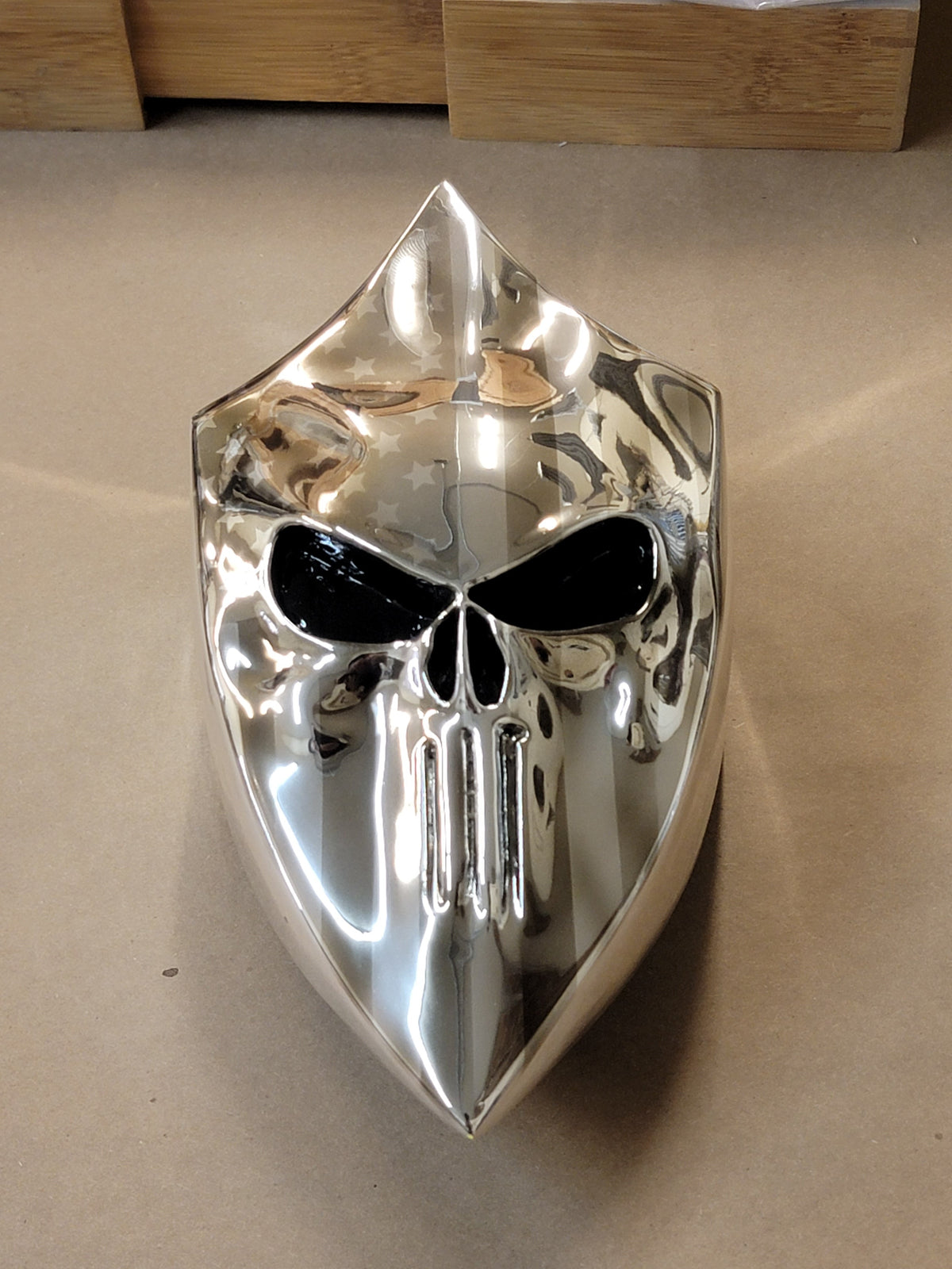 Chrome Harley horn cover with punisher stretching through