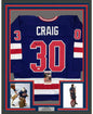 Framed Autographed/Signed Jim Craig 35x39 Blue 1980 Miracle On Ice United States Hockey Jersey JSA COA