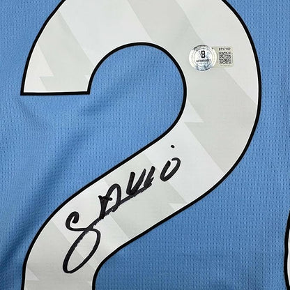 Framed Autographed/Signed Savinho 35x39 Manchester City Blue Soccer Futbol Jersey Beckett BAS COA