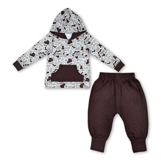 Camo hoodie with a kangaroo pocket in shades of gray and brown, paired with solid brown pants featuring an elastic waistband.