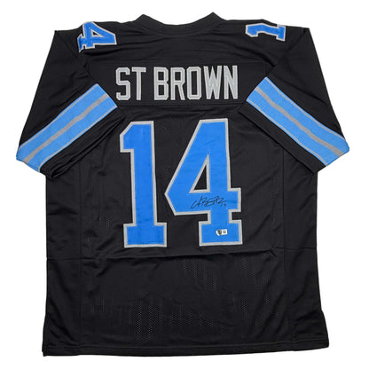 Autographed/Signed Amon-Ra St. Brown Detroit Black Football Jersey Beckett BAS COA