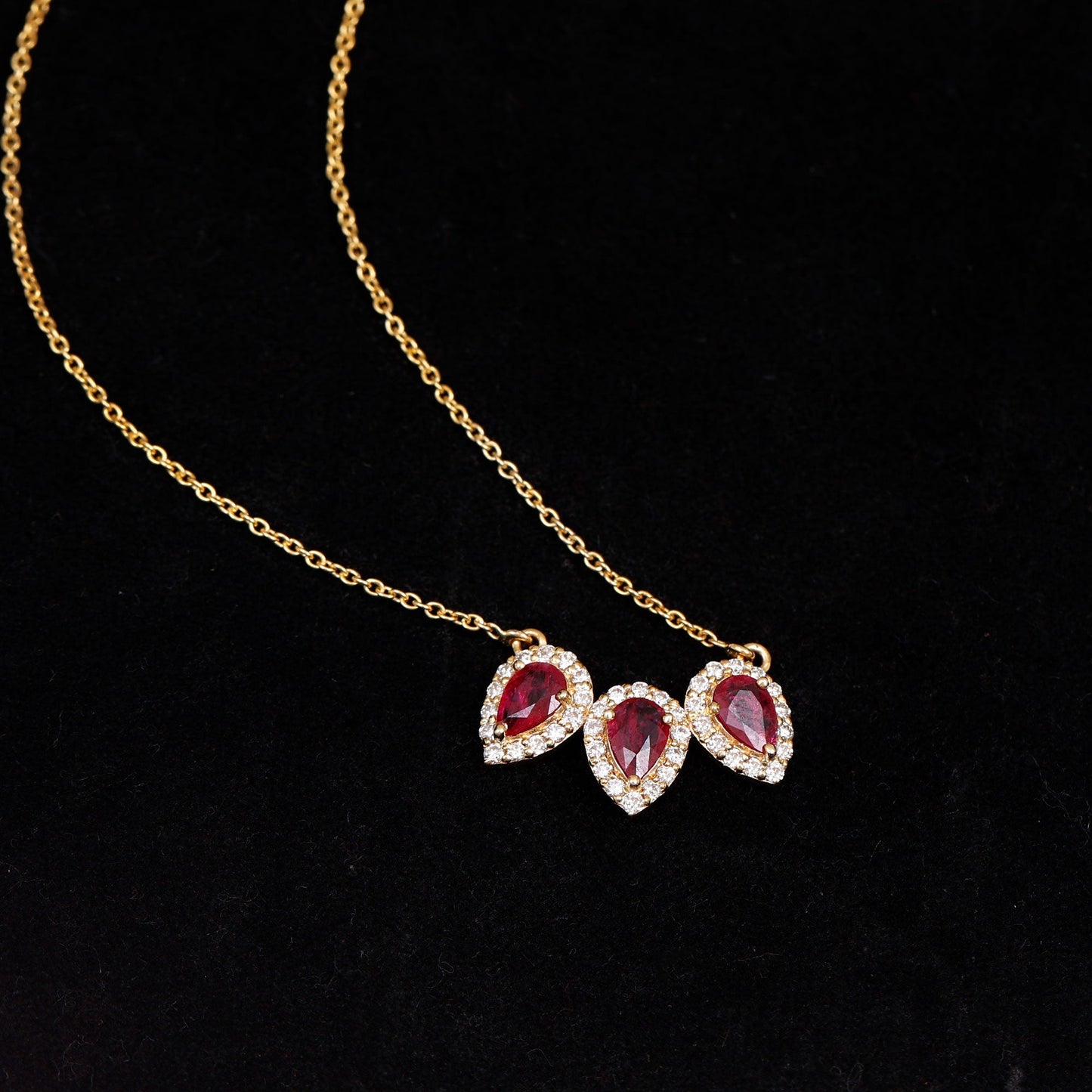 Pear Cut Lab Created Ruby Three Stone Necklace with Moissanite Halo
