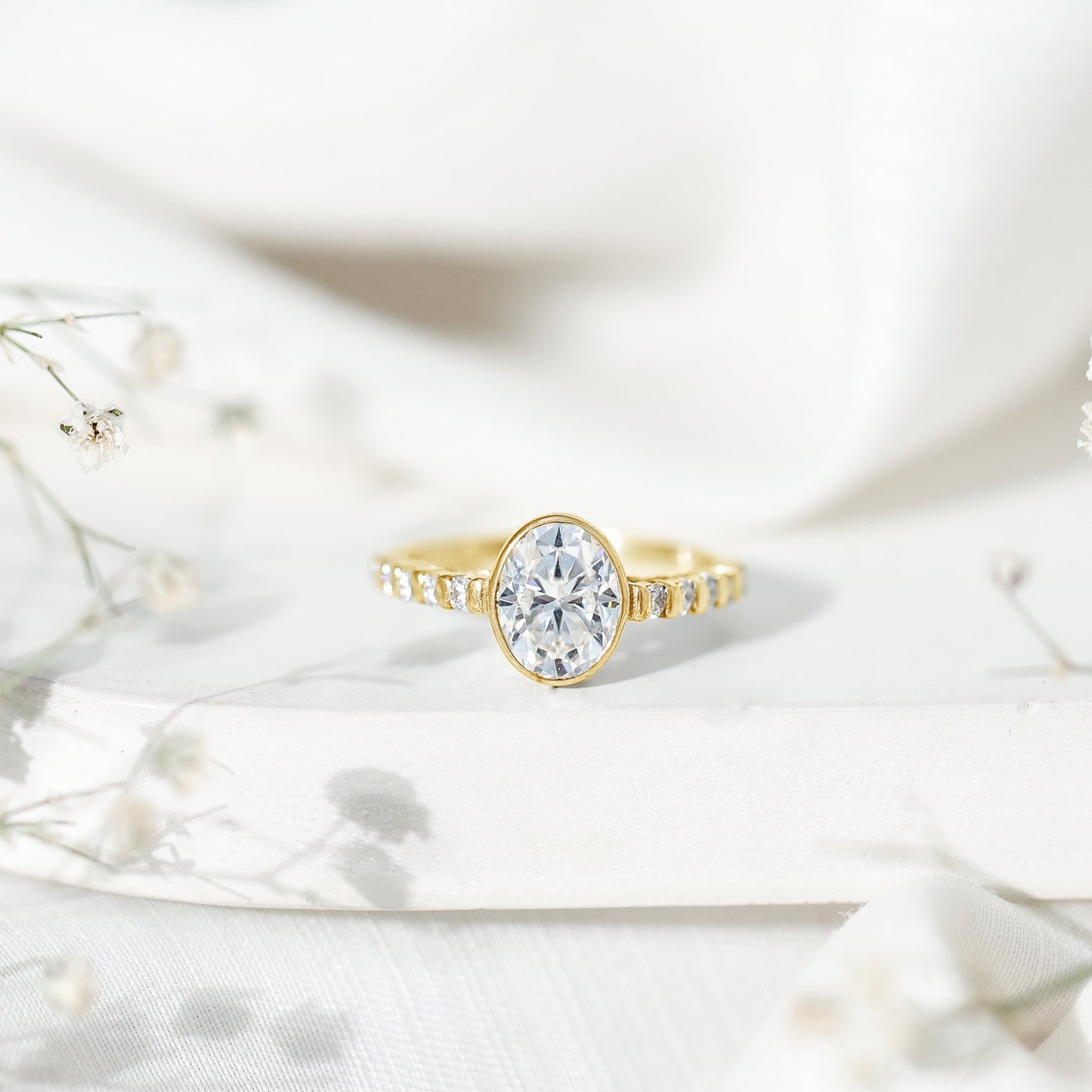 Bezel Set Moissanite Oval Engagement Ring with Side Stones