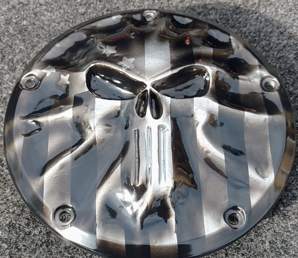 Punisher stretching through black and silver Flag Harley derby cover