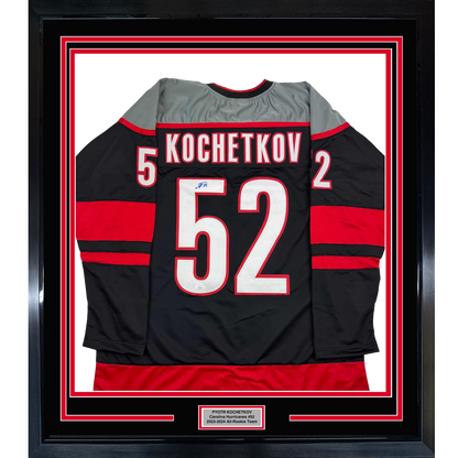 Framed Autographed/Signed Pyotr Kochetkov 35x39 Carolina Black Hockey Jersey JSA COA